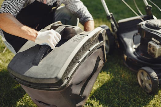 pexels-photo-5163429-5163429 An adult man replacing a lawn mower bag on a sunny day in the yard.